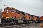 Intermodal rolls past tied down grain train